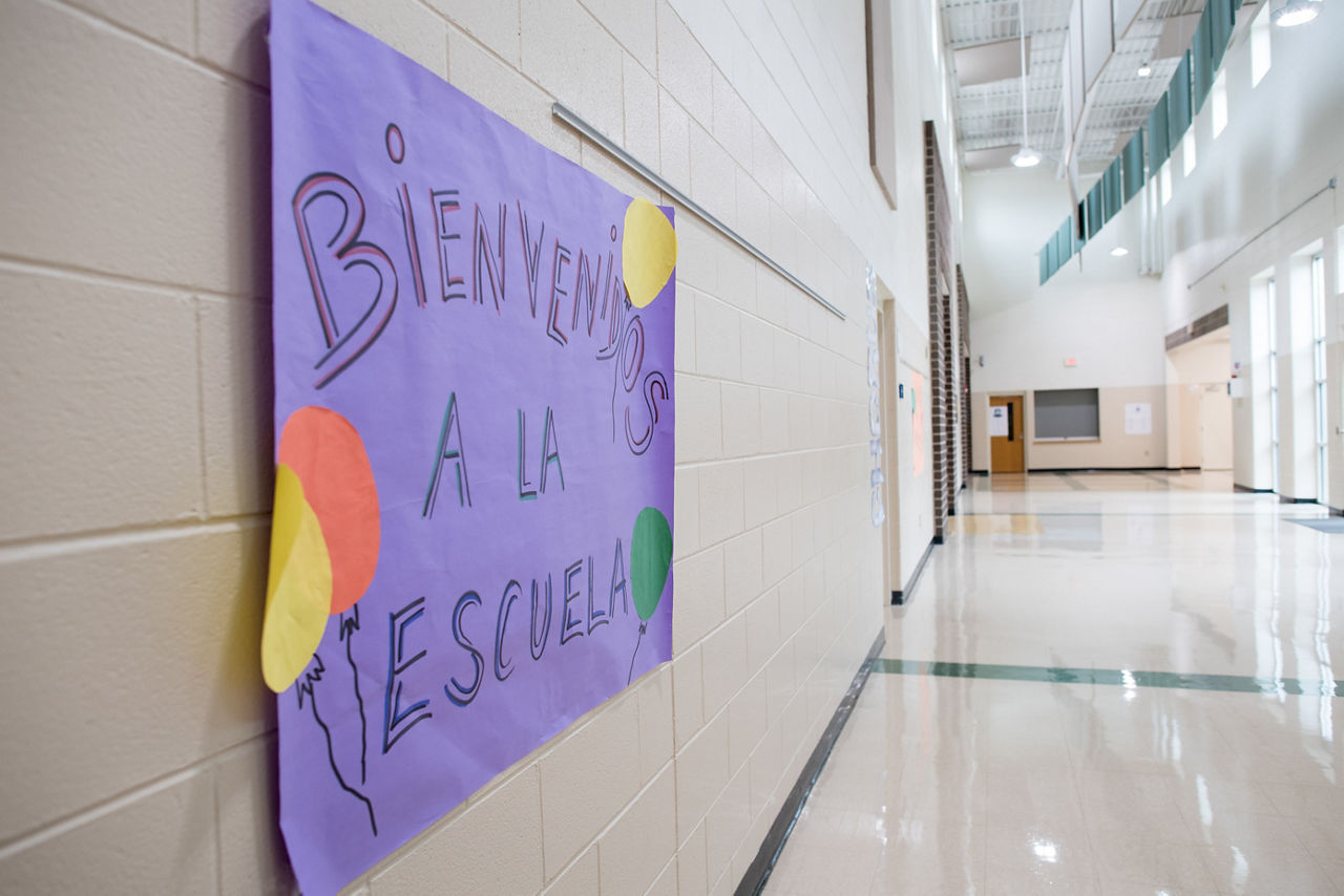 A sign welcomes students to Tanglewood Middle School in Spanish, where 40% of the students are Spanish-speaking. Tanglewood is participating in the OnTrack Greenville program to identify risky behaviors and better engage students.