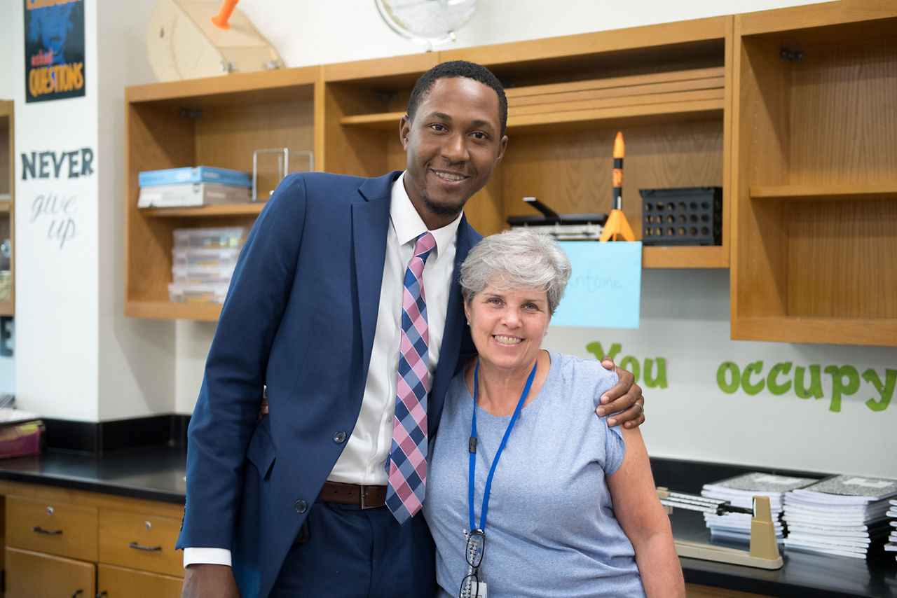Principal Edward J. Anderson hugs his fourth grade teacher, Susan McCoy, who had a great impact on his development as a student. She is now a science teacher at Tanglewood Middle School, which is participating in the OnTrack Greenville program to identify risky behaviors and better engage students.
