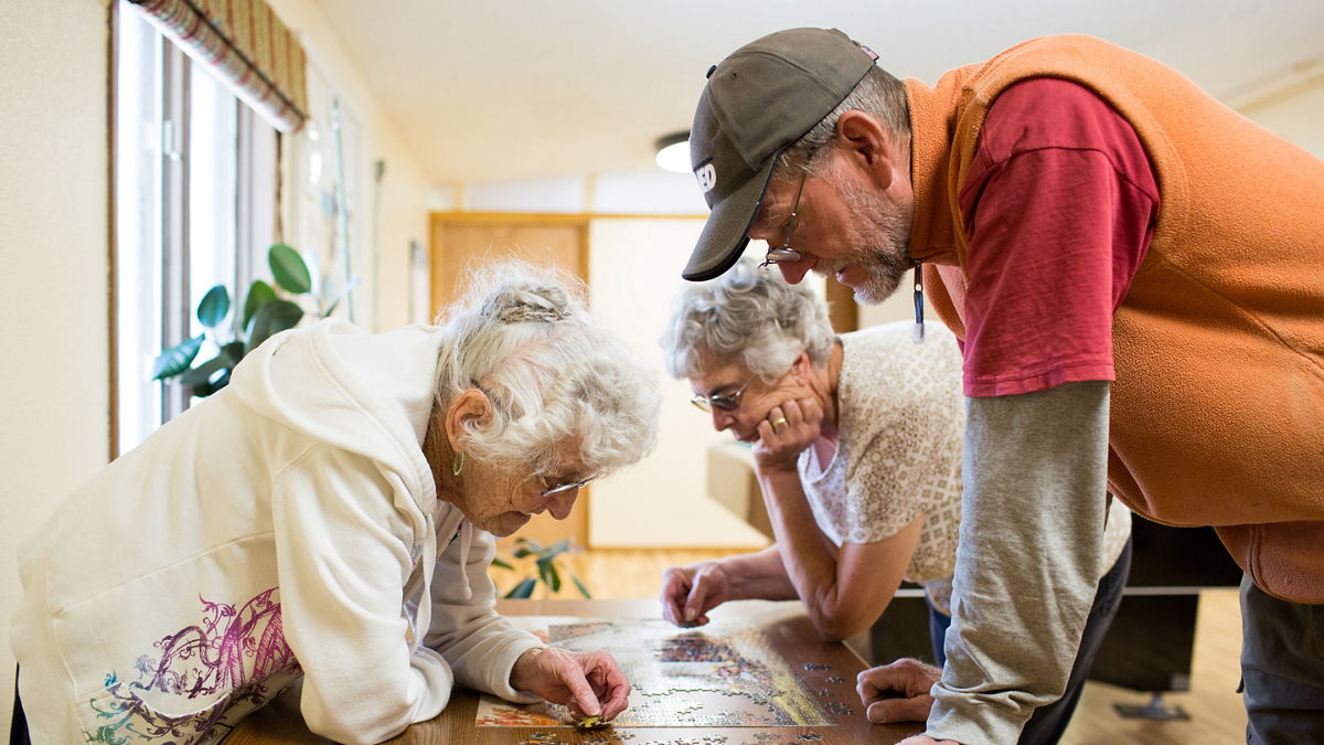 Helen Pettus, Debra Lysne and Scott Kaysen work on a puzzle together at the Lake County Senior Center in Leadville, Colorado.