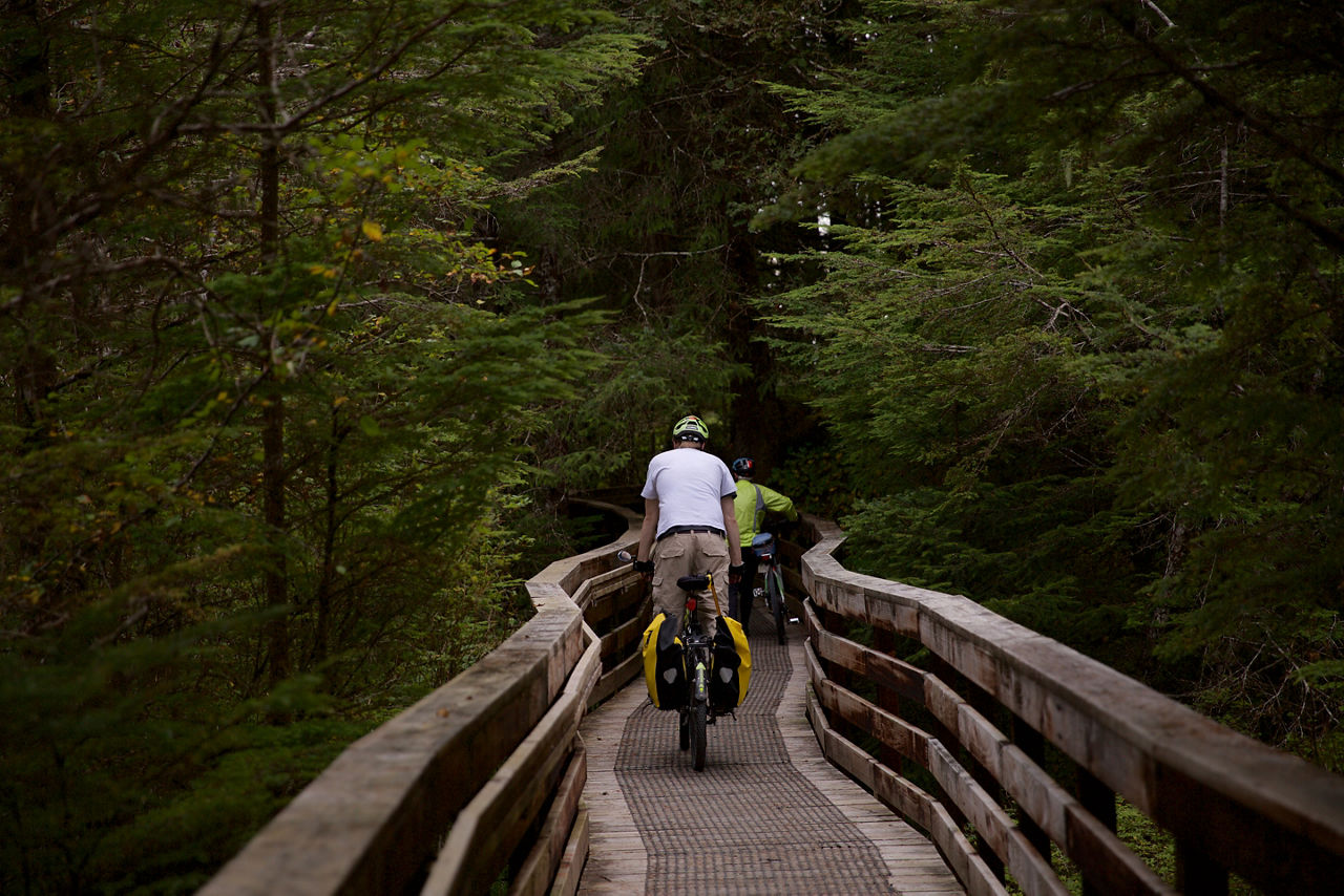 SITKA, ALASKA - SEPTEMBER 2019: Bicyclists using the Cross Trail located in Sitka, Alaska.