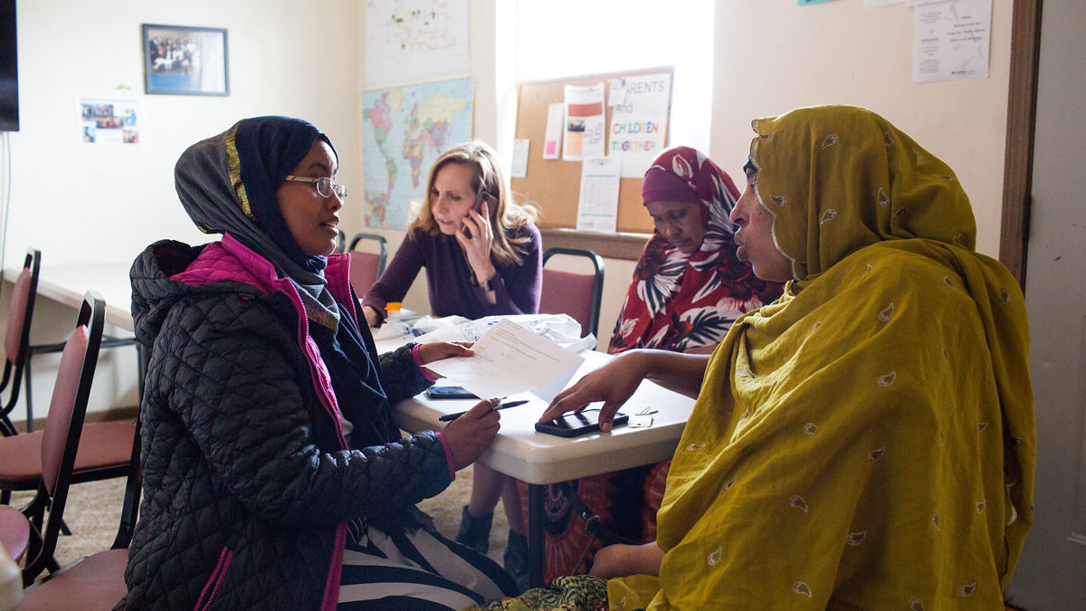2019 RWJF Culture of Health Prize Kansas Finney Community health worker Ifrah Farah and Birgit Lemke make phone calls for Somali refugees Koos Husen (in yellow) and Asli Muhamud (in red) at LiveWell Finney County Neighborhood Learning Center in Garden City, Kansas.  LiveWell helps refugees and immigrants with health care, housing and job applications and offers classes in English, nutrition and other life skills.