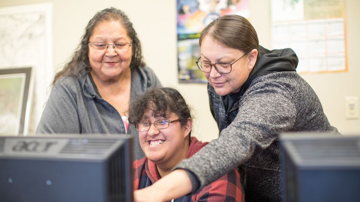 Todd County, South Dakota, 2019. Rosebud Reservation.The Lakota Studies Tipi Building located at Sinte Gleska University.Dera Iyotte (right) teaches Tribal History as well as a Lakota Astrolgy class. She has a degree in Cultural Resource Management. Dera goes to the Headstart Program and speaks with parents about natural plants + herbs that can be used in place of pharmaceuticals. Ta'olowan Luta Winstone (center).Marion Fast Horse Morales (left).