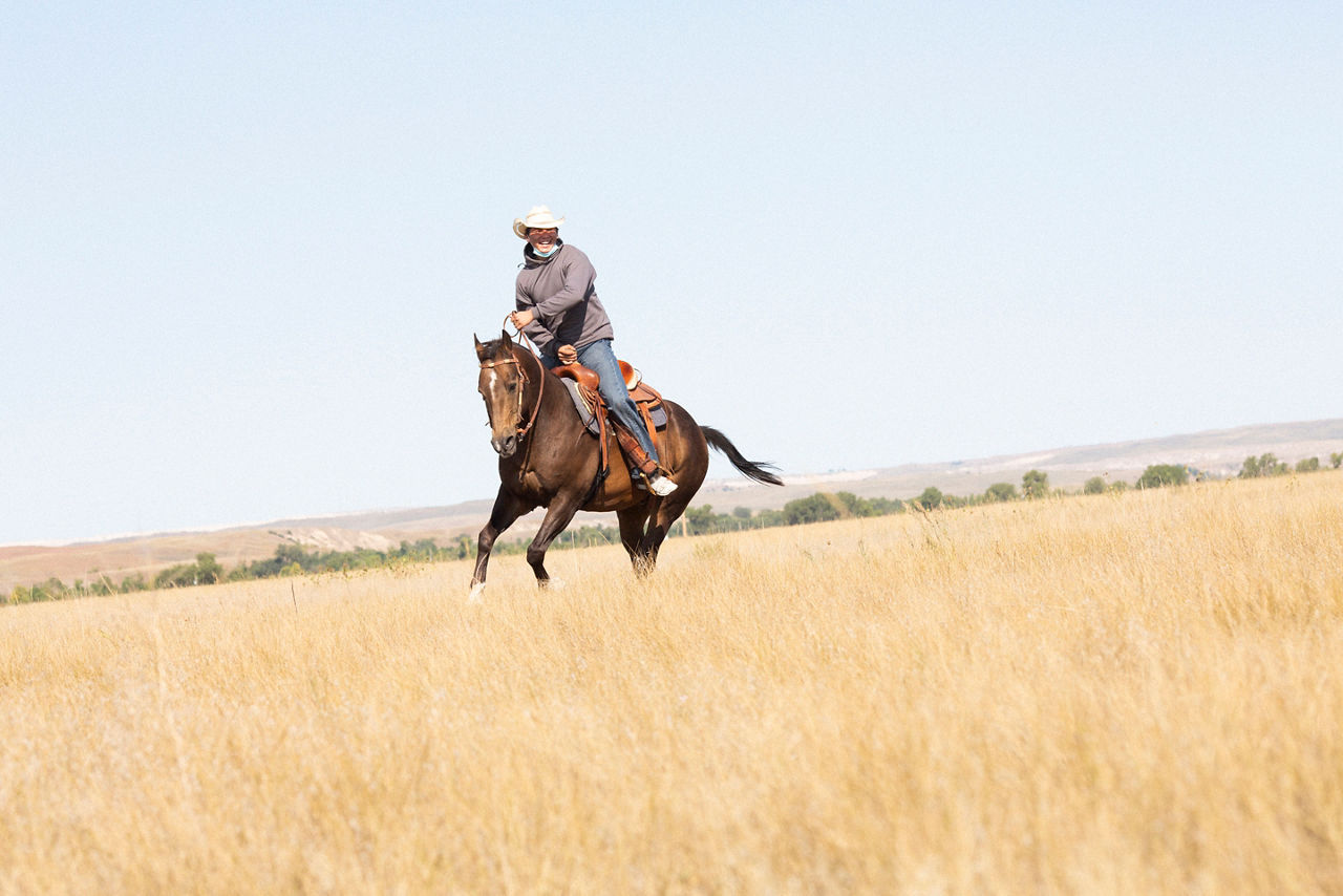 Taylen Garnette on a ride outside the corral. The Thunder Valley Community Development Corporation workforce cohort participates in Equine Therapy. The exercise encourage mental health through the physical interaction between horse and human. The participants work on trust and relaxation as they ride the horses without a saddle or reins.The people of Thunder Valley are tapping their warrior spirits to reclaim their identities, culture, and language. They are committed to clearing a path forward for generations to come. At the core of the Culture of Health journey is how action is taken by the community—not for the community. The mission includes reclaiming language and culture, healing from trauma, providing homes and creating a safe and regenerative community, and developing work-force skills by looking at the whole person and getting them ready for the workforce physically, mentally, socially, and spiritually. Pine Ridge Reservation, South Dakota. September 17, 2021 (Photo by Samantha Appleton)The people of Thunder Valley are tapping their warrior spirits to reclaim their identities, culture, and language and heal from historical and present-day trauma. They are committed to clearing a path forward for generations to come. At the core of the Culture of Health journey is how action is taken by the community—not for the community. The mission includes reclaiming language and culture, healing from trauma, providing homes and creating a safe and regenerative community, and developing work-force skills by looking at the whole person and getting them ready for the workforce physically, mentally, socially, and spiritually. Pine Ridge Reservation, South Dakota. September 17, 2021 (Photo by Samantha Appleton)The people of Thunder Valley are tapping their warrior spirits to reclaim their identities, culture, and language and heal from historical and present-day trauma. They are committed to clearing a path forward for generations to come. At the core of the Culture o