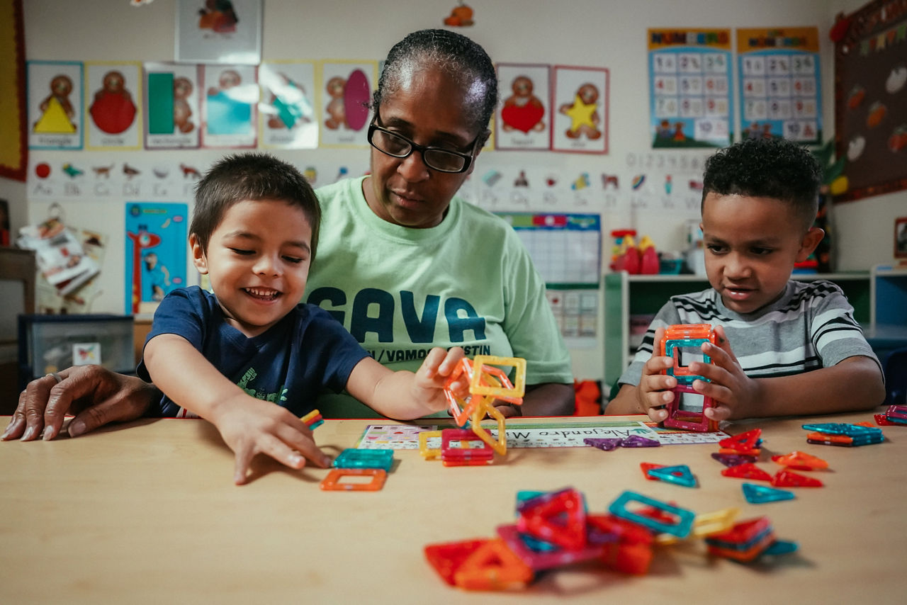 Ms. Loretta Johnson playing with magnetic tiles with King Johnson and Aiden Briggs at her Family Childcare facility.