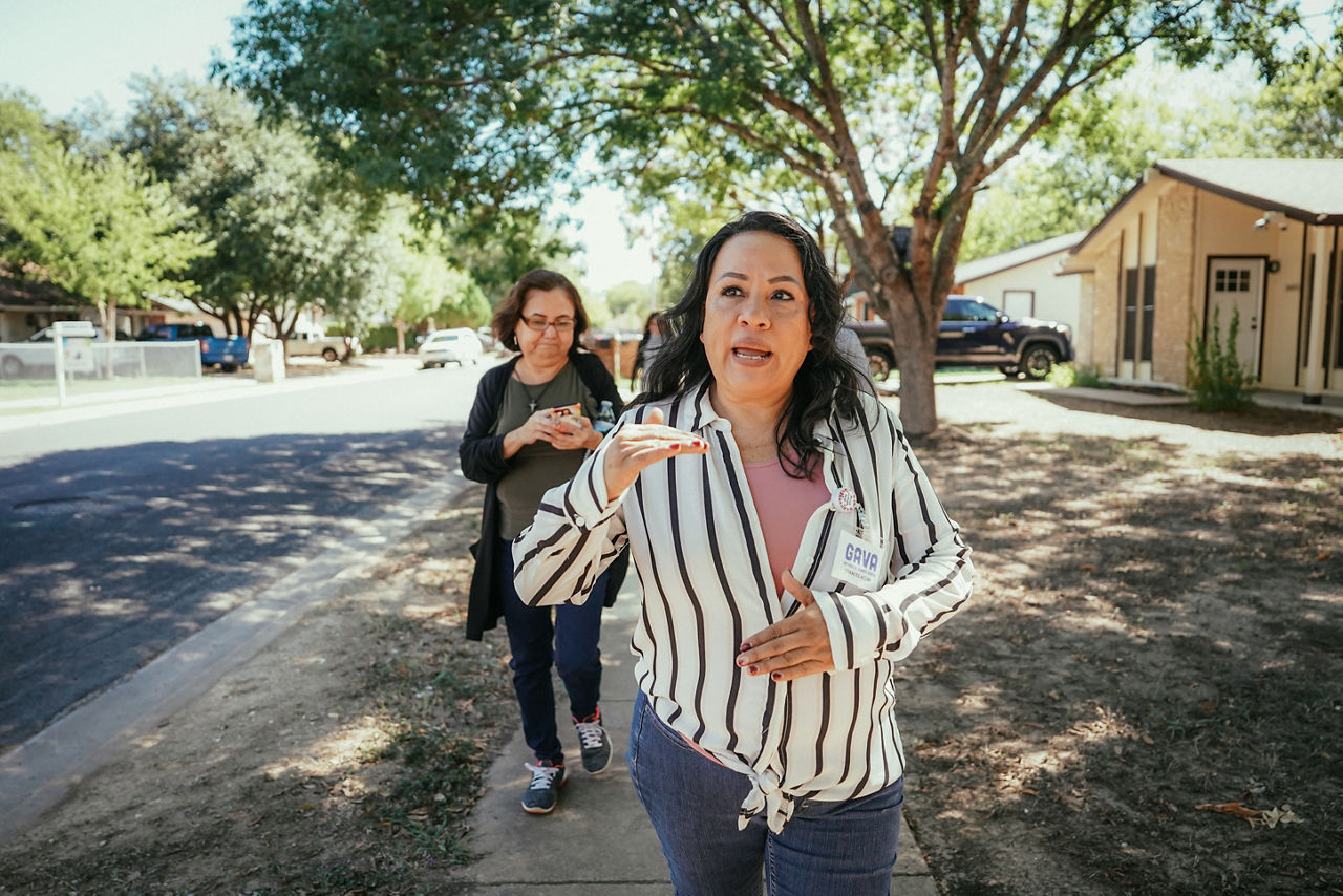 Frances Acuna, Climate Resilience Lead Organizer (GAVA team member) and Dove Springs neighborhood residents, walks to the E. Williamson Creek Greenbelt with the other community leaders and residents. The group have been working to transform the flood zone into a neighborhood asset for climate resiliency and recreation.