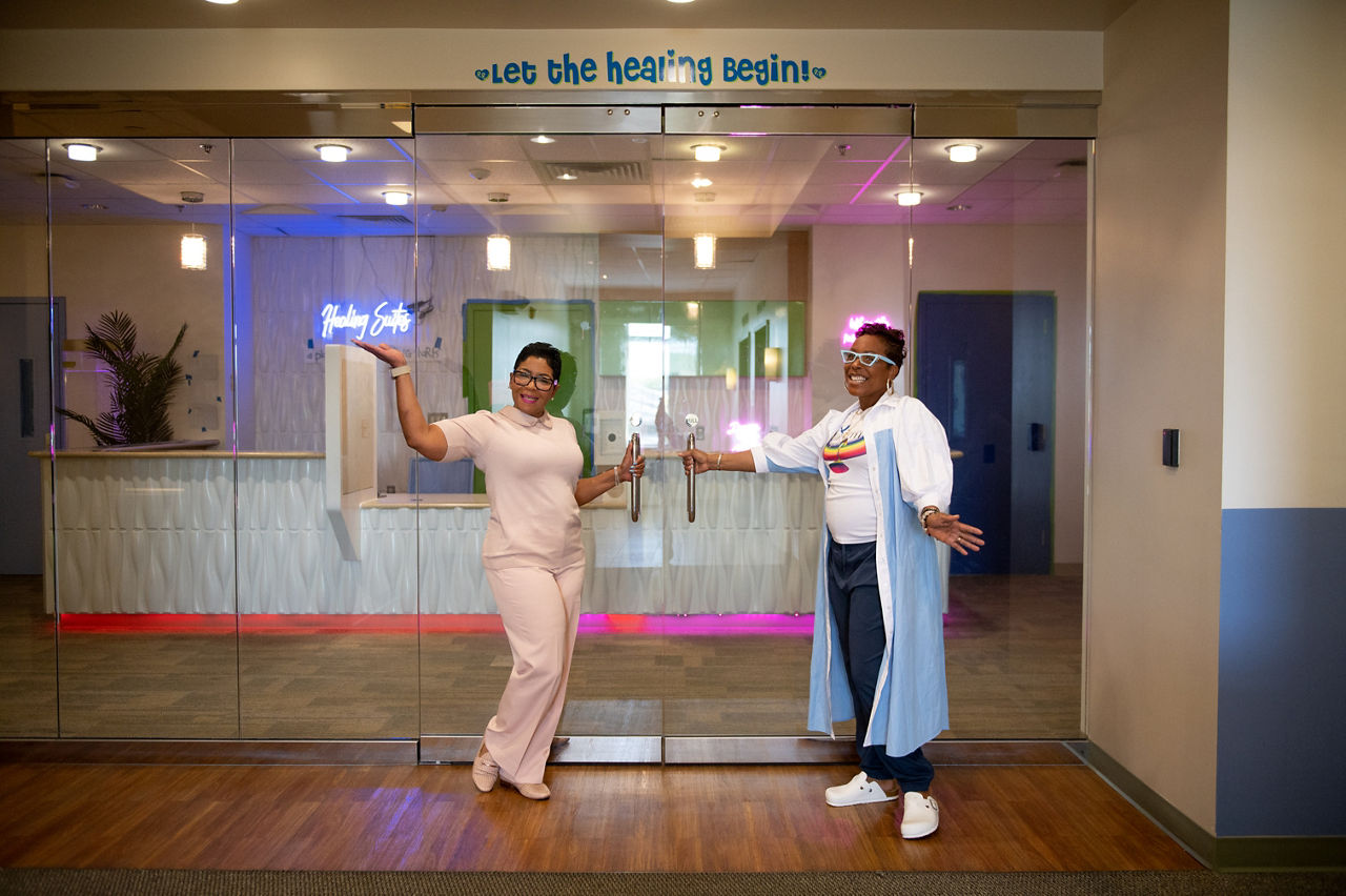 Monica Boddie, left, and Cyrus Nusumstand in front of the Transformation Nation Healing Suites, which were conceptualized and created to act as a therapy hub for Baltimore children dealing with trauma.