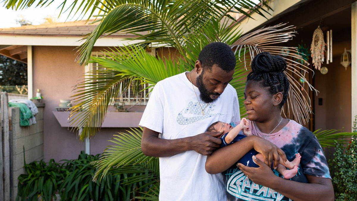 Jessica Brown and Chris Johnson hold their 1 week old baby Noah in front of Jessica's home in Carson, California on October 22, 2023.