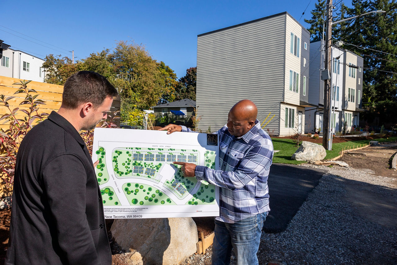 Housing developer Reggie Brown shows the plans of Wisteria Properties, a recently completed 40 unit missing middle housing apartment complex in South Tacoma, Washington on October 5, 2023.