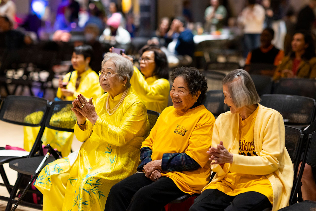 Members of the Golden Bamboo Walking Club watch a performance at Kaleidoscope, the annual Tacoma Arts Month Opening Party in Tacoma, Washington on October 5, 2023.  The Golden Bamboo Walking Club is a Vietnamese senior walking group with a mission to bridge communities and generations through arts, culture, education and business.