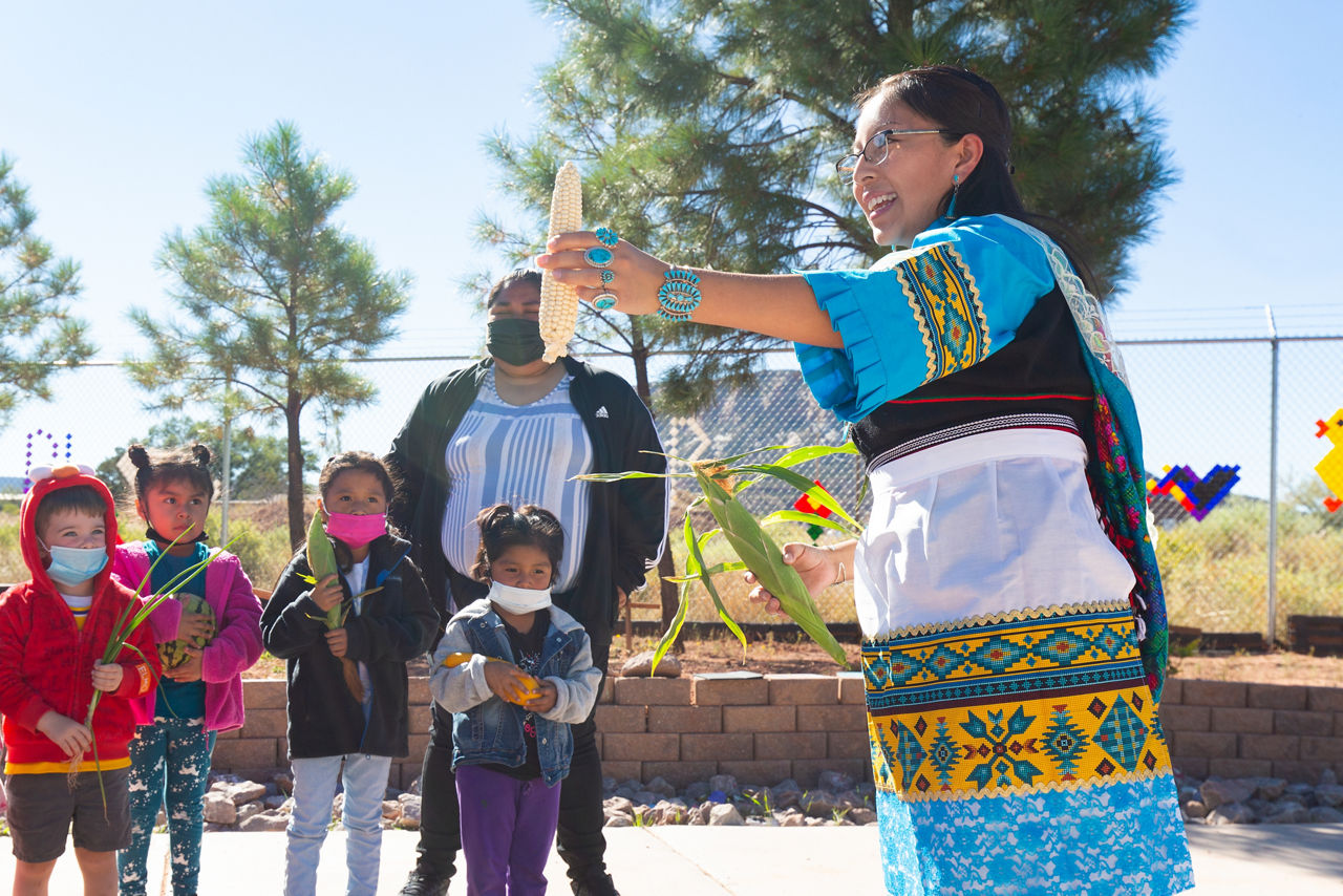 Kenzie Bowekaty, Food Sovereignty Leader for the Zuni Youth Enrichment Project, leads a blessing ceremony with the Headstart class during their visit to the gardens and greenhouse, which are walking distance from the school. Food that is harvested from these gardens goes to feed the students at the school.