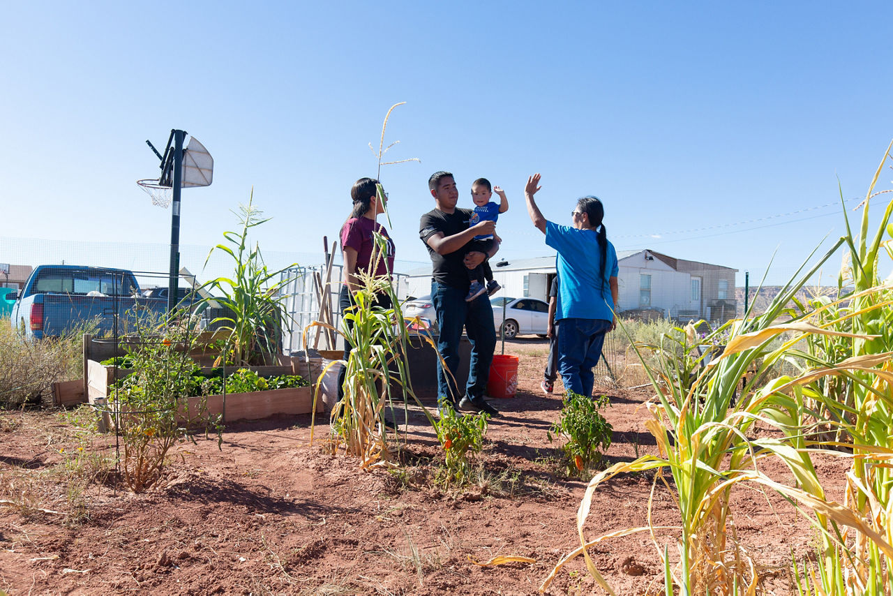 Kenzie Bowekaty, Corey Seowtewa, Carter Bowekaty, and Devoria Bowekaty in the garden they planted outside their home. Their garden forms part of the Zuni Youth Enrichment Project’s food sovereignty initiative to partner with families to reintroduce traditional gardening practices at home.