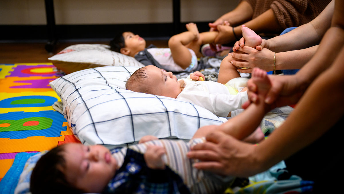 Mothers participate with their children in a baby massage class at the Children's Home Society of New Jersey in Trenton, N.J.