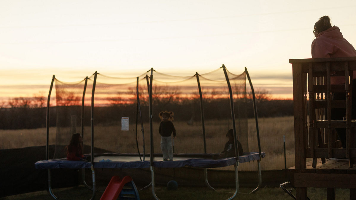 A family outside during sunset.