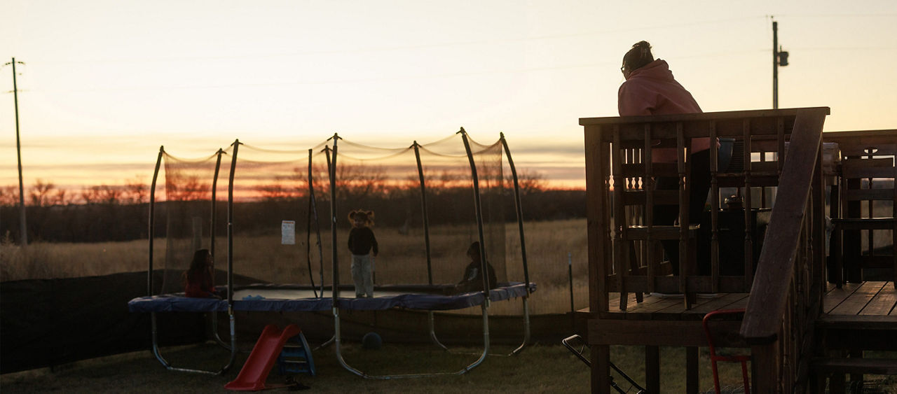 A family outside during sunset.