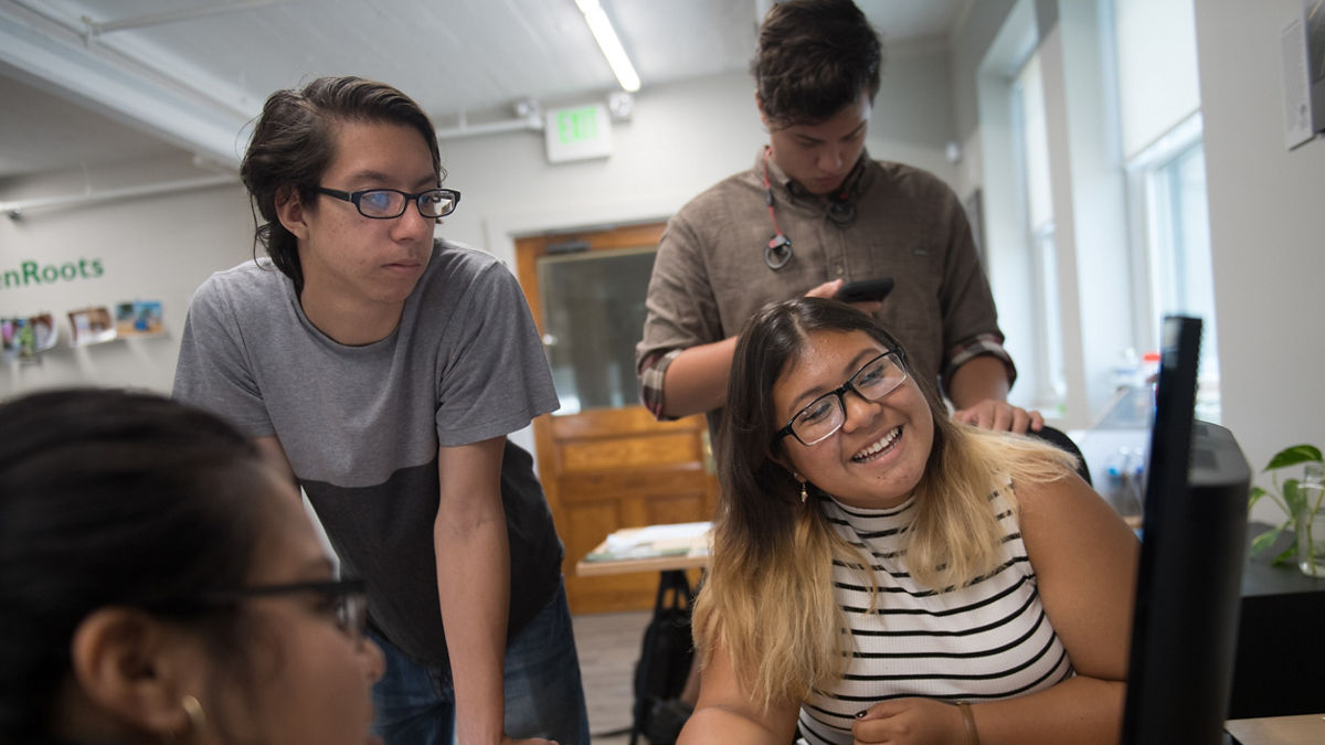 Members of the ECO (Environmental Chelsea Organizers) Youth, work on a campaign together at the GreenRoots office, which is situated on the Chelsea Creek waterfront. (AEM DAM Chelsea Story)