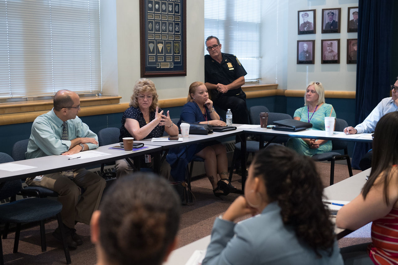 Members of HUB meet at the Chelsea Police Department in the community room. HUB is a weekly gathering of agencies that provide social and medical services within Chelsea, where participants can brainstorm and connect in order to better serve their clients' needs. (AEM Chelsea MA story image)