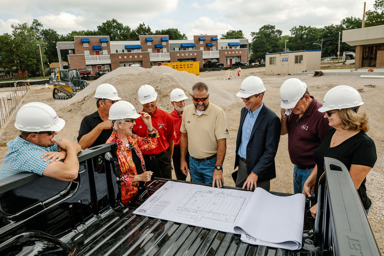 Iola, KS - August 1, 2017 - Members of THRIVE Allen County, construction staff, and and community officials discuss plans for a new grocery store in downtown Iola.