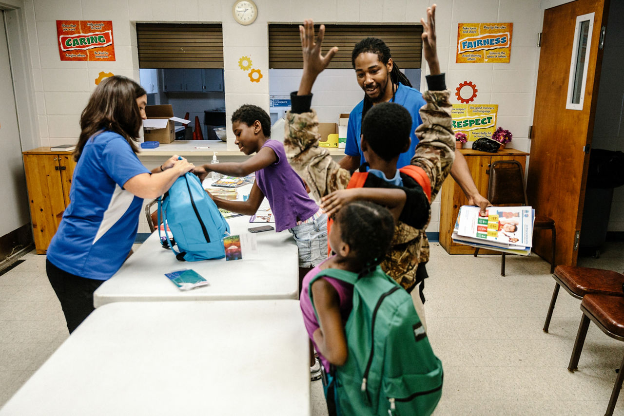 Vicksburg, MS - Aug 3, 2017 - Michele Connely, Executive Director of United Way in Vicksburg, distributes toothbrushes, pencil cases, coloring books, and educational literature to a local family during a back-to-school childrens health care event.