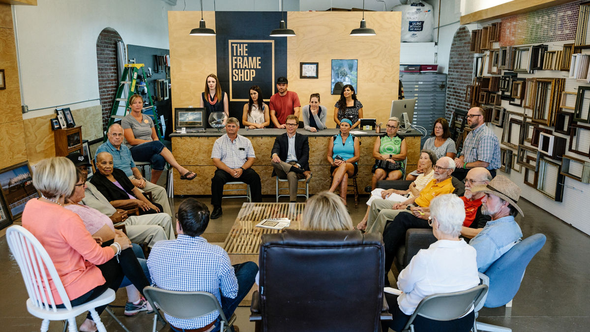 Humboldt, KS - July 31, 2017 - David Toland (center), CEO of THRIVE Allen County, leads a community conversation at a frame shop in downtown Humboldt.