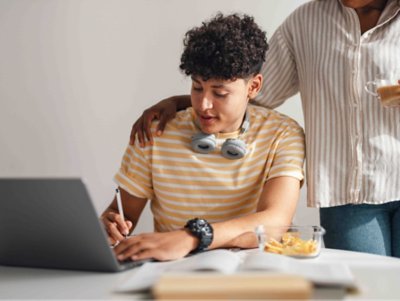 Student at computer with parent.