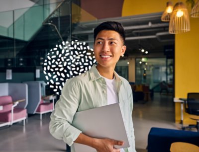 Student in a shared space with laptop.