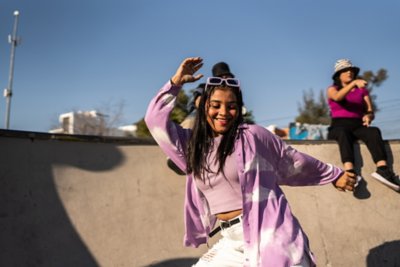 Person dancing having fun at skate park.
