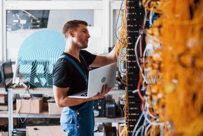 Person working on server racks.