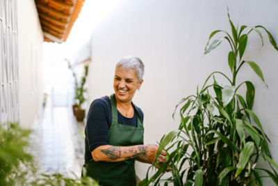 Person gardening and smiling.