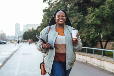 Smiling person walking in city