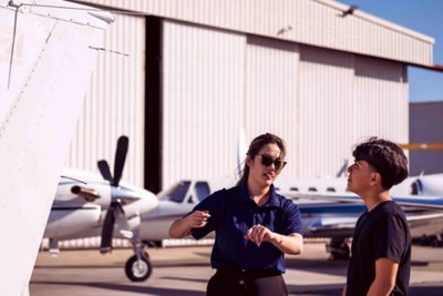 Student studying plane instructor.