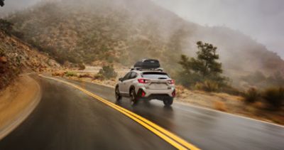 Hybrid Crosstrek driving on wet road