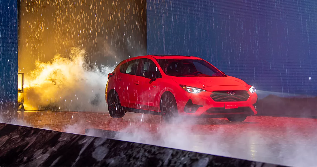 2024 Subaru Impreza driving through water, simulating a rainstorm, during its reveal at the Los Angeles Auto Show