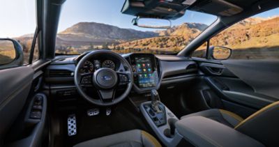 The dashboard, steering wheel, and in-dash touchscreen of a 2024 Subaru Crosstrek