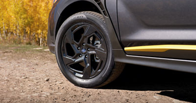 A close up of a front tire of the 2025 Subaru Crosstrek, representing its 8.7-inch ground clearance