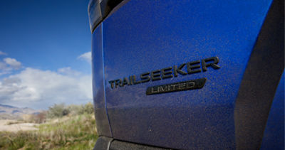 Close-up of Trailseeker Limited badge on blue vehicle body panel.