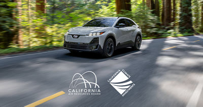 A 2027 Subaru Uncharted electric SUV drives through a forest.