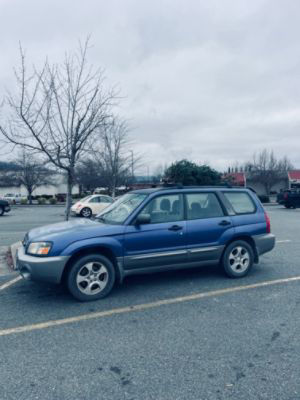 A blue Subaru Forester in a parking lot