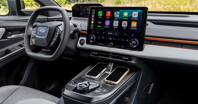 Interior view of the steering wheel and touchscreen in a 2026 Subaru electric vehicle SUV