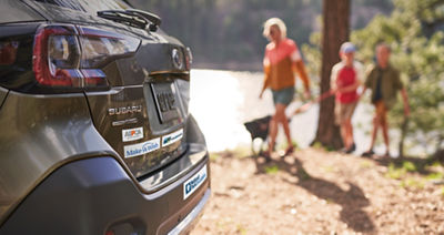 Subaru trunk showing bumper stickers for ASPCA, Make-A-Wish, Meals on Wheels and National Park Foundation