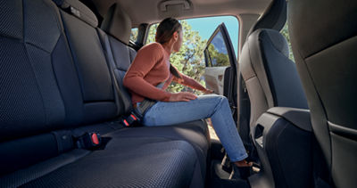 A woman sitting in the rear passenger seats of a 2025 Subaru Crosstrek