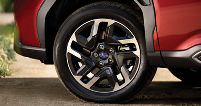 A close-up of an alloy wheel on a red 2026 Subaru Forester small SUV.