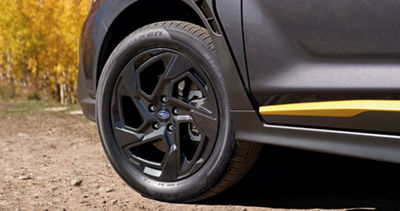 A close up of a front tire of the 2026 Subaru Crosstrek, representing its 8.7 inch ground clearance. 