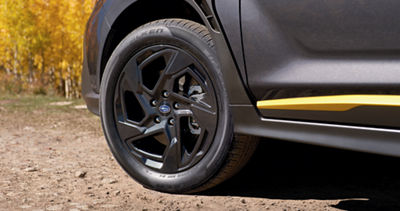 A close up of a front tire of the 2026 Subaru Crosstrek, representing its 8.7-inch ground clearance. 