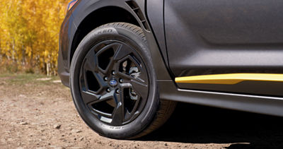 A close up of a black alloy wheel on a 2026 Subaru Crosstrek crossover SUV.