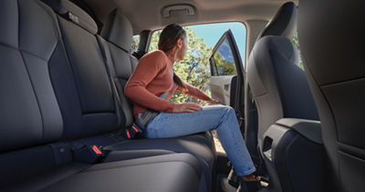 A woman sitting in the rear passenger seats of a 2026 Subaru Crosstrek. 