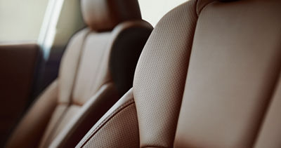 A close-up of the ventilated leather seats in a Subaru Touring XT sedan.