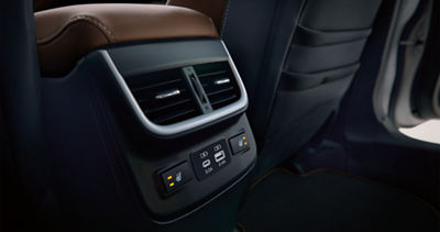 A close-up of the rear vents and heated rear seats controls in a Subaru Touring XT.