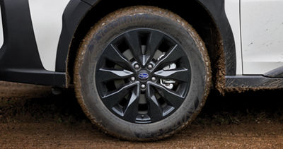 A close-up of an 18-inch glossy black alloy wheel on a Subaru Outback Onyx Edition.
