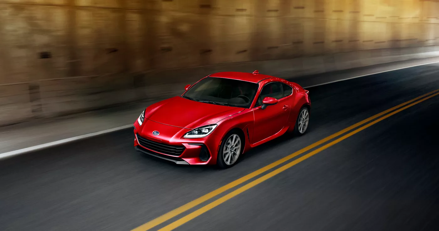 A red Subaru BRZ in a highway tunnel