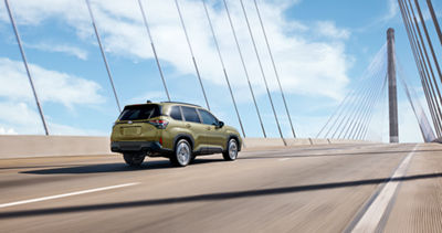 2026 Subaru Forester Hybrid driving on highway — 40% better city MPG
